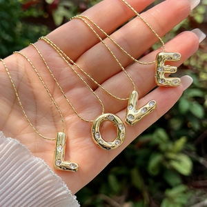 Bubble A-Z letter pendant necklaces with 18K gold plating and pavé cubic zirconia