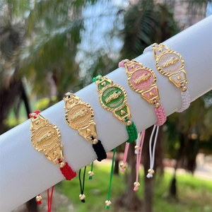 Detail of colorful woven bracelets with 18K gold plated San Judas Tadeo religious medals