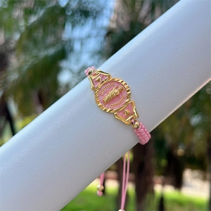 Pink woven rope bracelet with 18K gold plated religious medal and adjustable drawstring closure