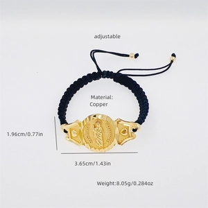 Detail of adjustable black woven bracelet with copper 18K gold plated Virgin Mary charm
