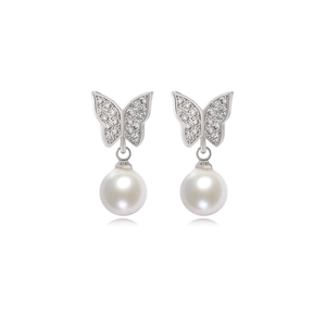 Detail view of silver butterfly earrings with sparkling zircon wings and white pearl drops
