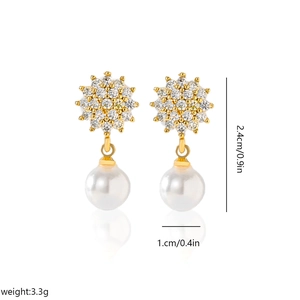 Detailed size view of sunburst pearl earrings with gold plating and zircon inlay