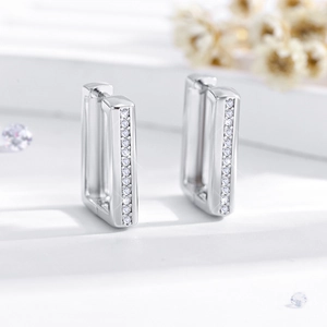 Detail of silver rectangular U-shaped hoop earrings with micro-pave white zircon stones