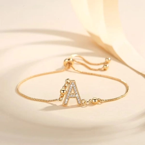 Detail of adjustable gold-plated letter A bracelet with pavé cubic zirconia inlay
