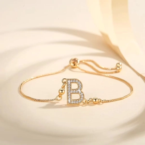 Detail showing gold plated adjustable B letter bracelet with cubic zirconia and slide clasp