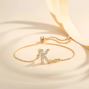 Detailed close-up of adjustable gold-plated letter K bracelet with pavé cubic zirconia