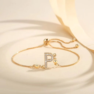 Detailed macro view of gold letter P pendant with sparkling cubic zirconia on a slider chain