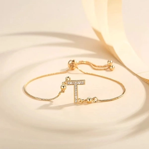 Detailed close-up of gold plated adjustable box chain bracelet with pavé zircon letter T