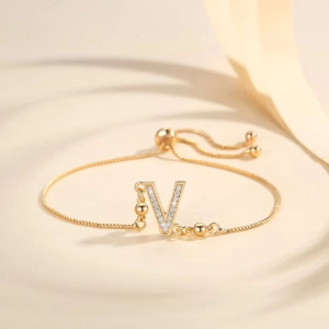 Detail of adjustable gold-plated bracelet with Zircon-encrusted letter V charm pendant