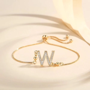 Detail of adjustable gold-plated letter W bracelet with sparkling pavé cubic zirconia