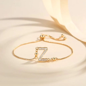 Detail of adjustable gold-plated bracelet featuring a zircon-studded letter Z charm