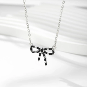 Détail du collier pendentif nœud avec chaîne argentée et zircons cubiques noirs