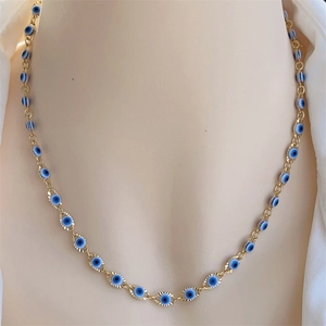 Detail of 18K gold-plated Evil Eye necklace with intricate blue and white bead charms