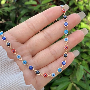 Detail of 18K gold plated evil eye bracelet featuring vibrant multicolor enamel beads