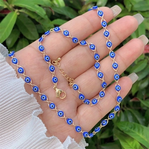 Detail of 18K gold-plated Evil Eye necklace with blue beads and adjustable lobster clasp