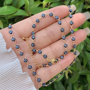 Detail of 18K gold plated evil eye necklace set with adjustable lobster clasp closure