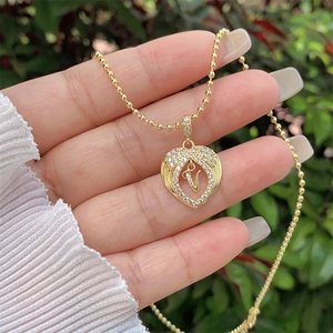 Close-up of 18K gold plated heart pendant with letter V and sparkling cubic zirconia