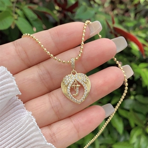 Detail view of a 18K gold-plated heart pendant with letter Y and white cubic zirconia