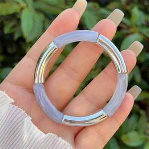 Detail of beaded resin bracelet with lavender marble texture and silver metal tubes