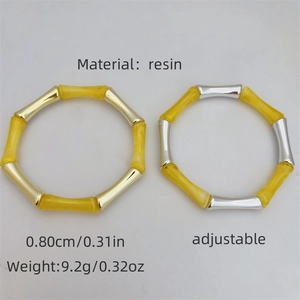 Bracciali regolabili in resina a forma di bambù con raccordi metallici nei toni oro e argento