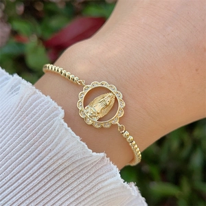 Close-up of 18K gold plated Our Lady of Guadalupe bracelet with cubic zirconia on wrist