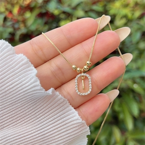 Detail of 18K gold plated letter I pendant with sparkling cubic zirconia on a box chain