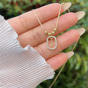 Detailed view of 18K gold plated letter J pendant necklace with sparkling cubic zirconia