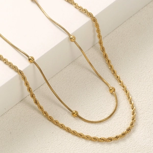 Golden stainless steel layered anklet set with delicate snake chain and thick rope chain