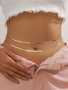 Detail of double-layer gold snake bone waist chain showing shiny metallic texture