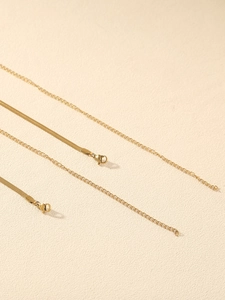 Detail view of golden snake bone waist chain with lobster clasp and extension link