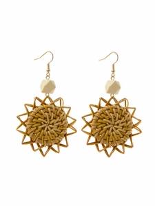 Macro shot of handmade bohemian woven rattan sunflower earrings with natural wood beads