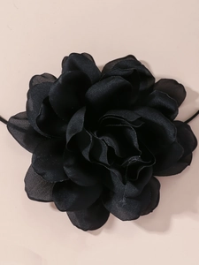 Macro detail of large black fabric flower choker with multilayered 3D floral petals