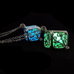 Luminous hollow cube tree of life pendant showing glowing blue and green light effects