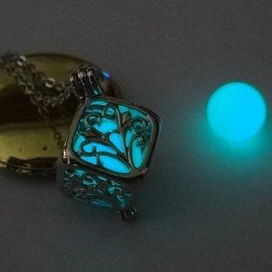 Detailed view of square hollow tree design pendant with glowing sky blue luminous bead