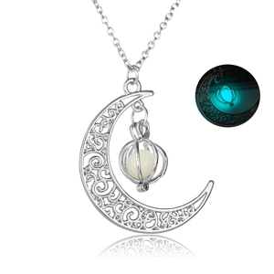 Detailed close-up of crescent moon glow necklace with luminous bead and silver chain