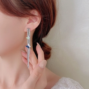 Elegant long tassel butterfly earrings with sparkling crystals and silver chain on model