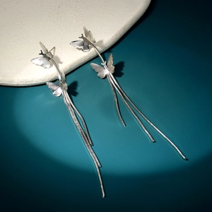 Detailed view of elegant silver butterfly earrings with long snake chain tassels