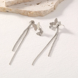 Detail of silver long butterfly tassel earrings with sparkling rhinestones and chains