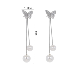 Close-up showing butterfly earring dimensions of 1.3cm width and 6cm length