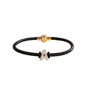 Braided leather bracelet with gold letter A charm and sparkling rhinestone inlay