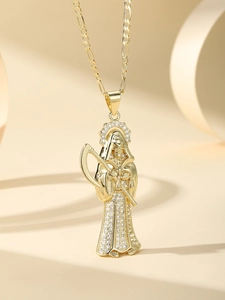 Macro detail of 14K gold plated Santa Muerte scythe pendant with sparkling zircons