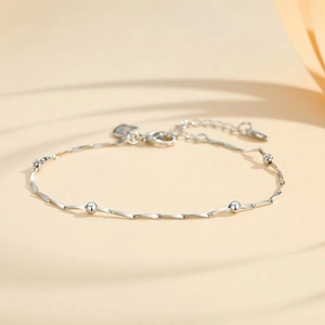 Minimalist silver beaded chain bracelet with geometric links and heart charm detail