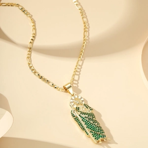 Gold Figaro chain necklace with St. Jude pendant featuring green micro-pave zircons
