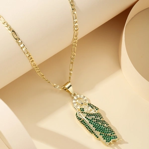 Gold Figaro chain necklace with religious St. Jude pendant featuring green zircon stones