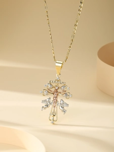 Macro detail of Caravaca cross pendant with angels and sparkling cubic zirconia stones