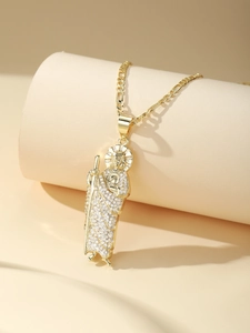 Close-up of Saint Jude religious pendant with gold finish and zircon micro-pave details