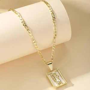 14K gold plated Figaro chain necklace with a rectangular St. Jude relief pendant
