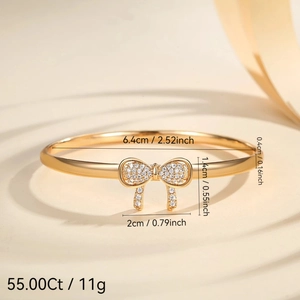 Gold-plated bow bracelet with micro-pave crystals and polished finish for women
