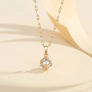 Gros plan détaillé d'un collier plaqué or avec pendentif en zircon sur une chaîne texturée