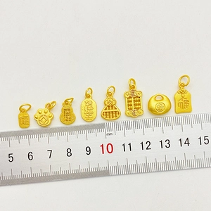 Gold-plated traditional Chinese charms including gourd and abacus charms with size ruler
